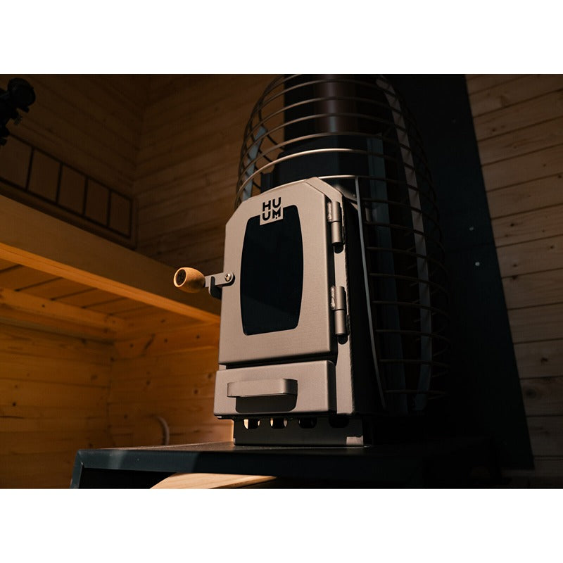 Interior view of the Celsium Ula Small with HUUM Sauna heater - High-quality wood-burning stove with viewing window and stone basket for an authentic sauna experience